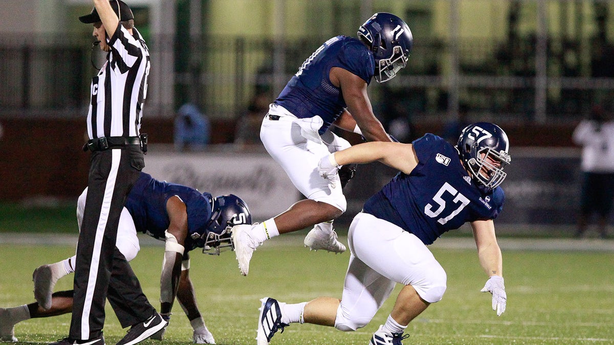 Jay Bowdry #5, Todd Bradley #11 and Gavin Adcock #57 of the Georgia Southern Eagles celebrate stopping the Georgia State Panthers on fourth down in the fourth quarter Nov. 30, 2019, at Allen E. Paulson Stadium in Statesboro, Georgia.