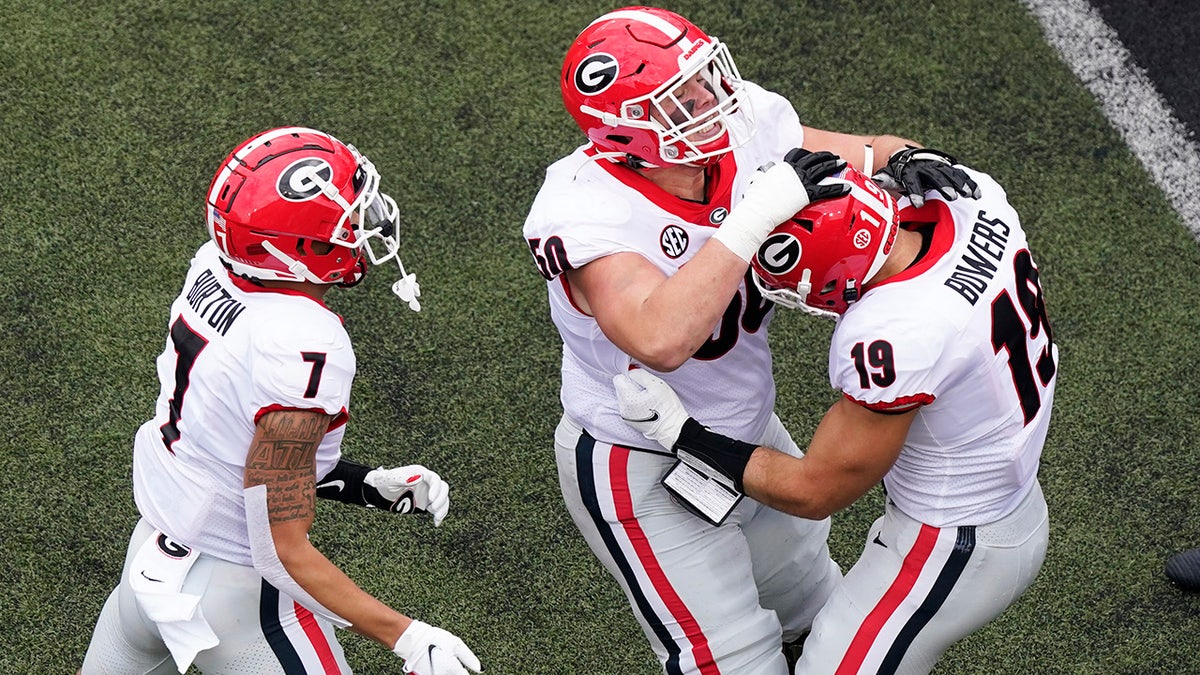 Georgia tight end Brock Bowers (19) is congratulated by Jermaine Burton (7) and Warren Ericson (50) after Bowers scored a touchdown against Vanderbilt in the first half of an NCAA college football game Saturday, Sept. 25, 2021, in Nashville, Tenn.