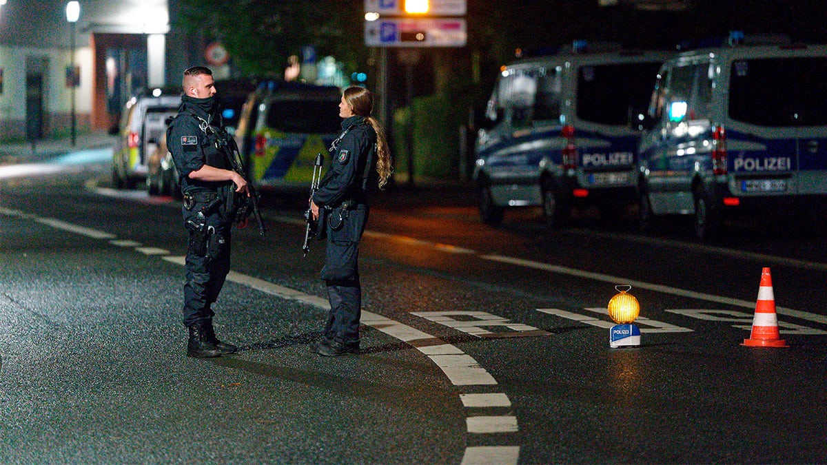 Police officers block a street in the city center during a police operation protecting the Jewish Community building in Hagen, Germany, Thursday, Sept. 16, 2021. 