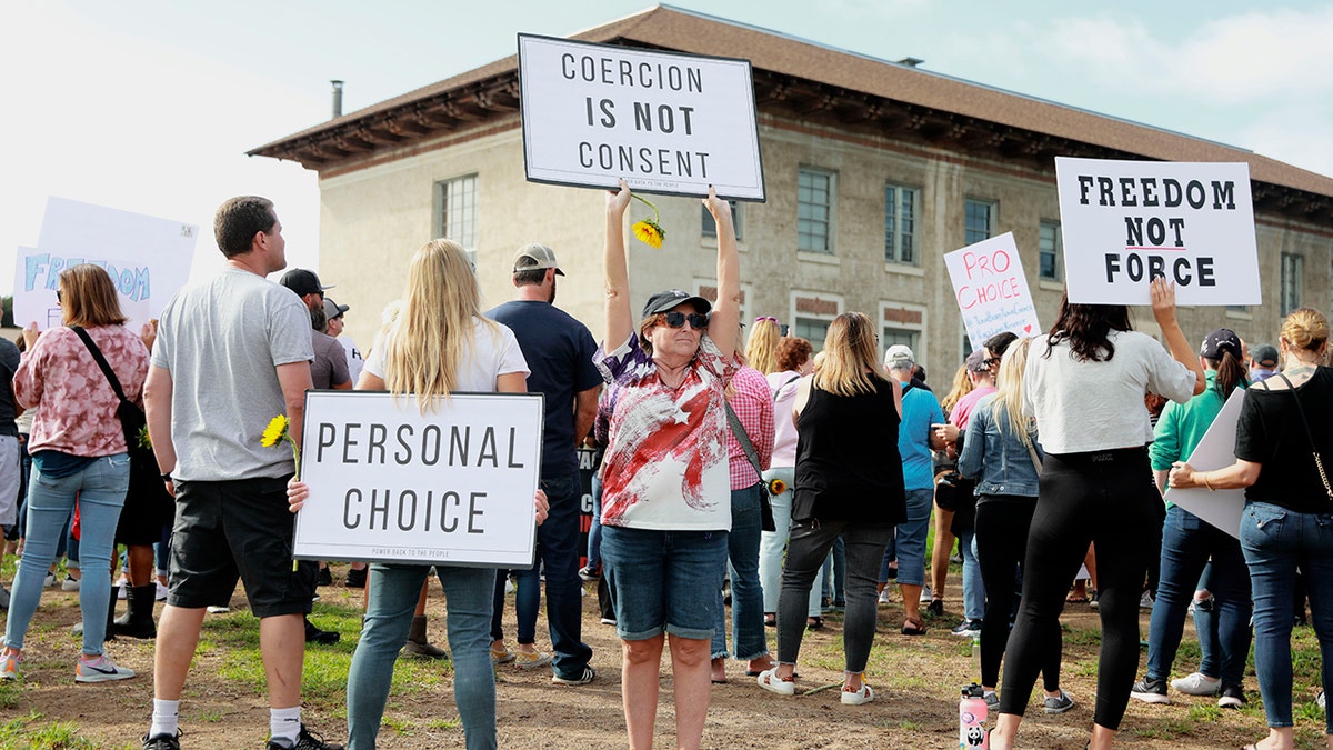 Anti-vaccine protesters stage a demonstration outside the San Diego Unified School District office in San Diego, California, Sept. 28, 2021.