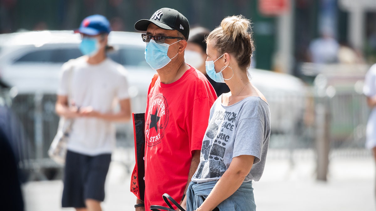People wear face masks in NYC during COVID-19 pandemic