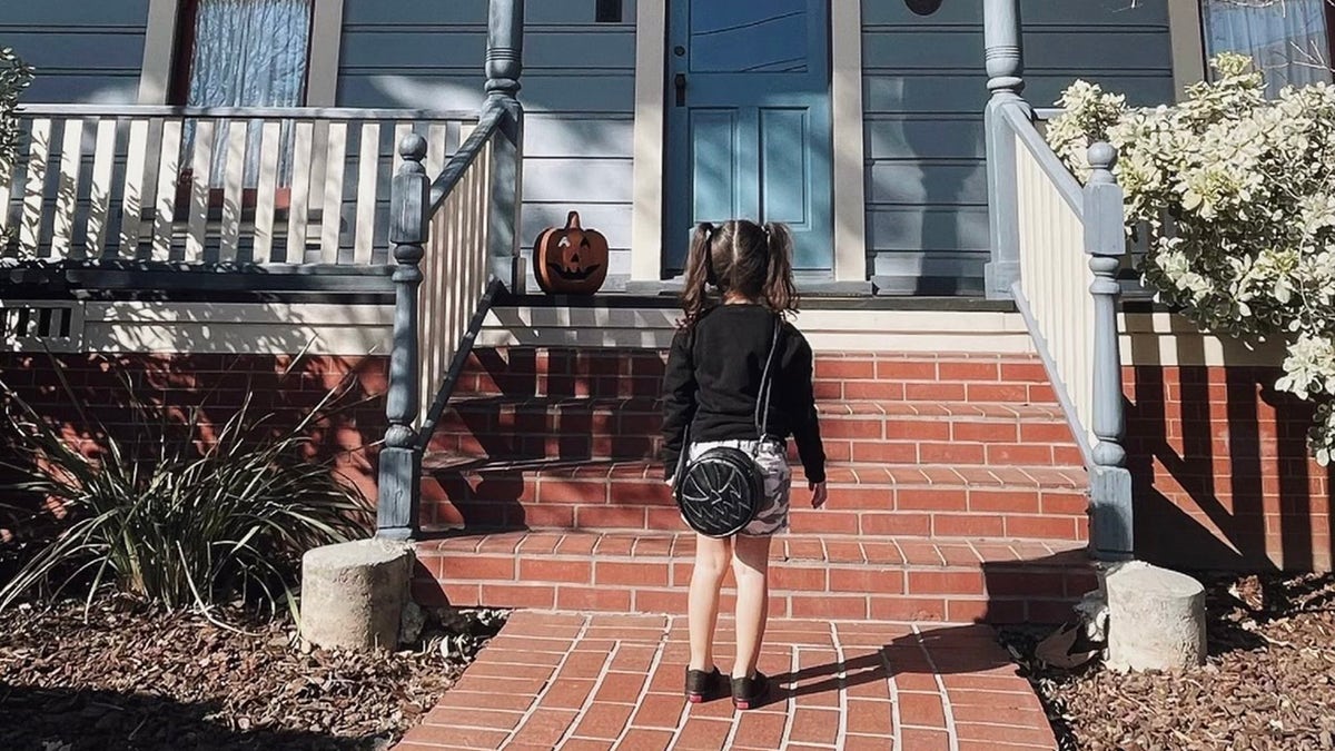 Aria Alvarado is seen in front of the character Michael Myers' house from the movie, "Halloween."
