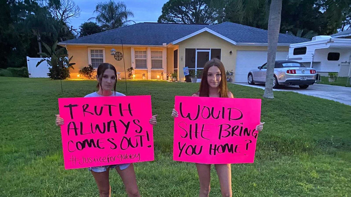 Protesters carry signs to home of Brian Laundrie on Thursday urging him to speak with police