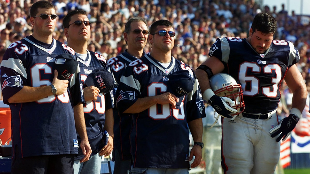 Prior to the Patriots-New York Jets game at Foxborough Stadium, New England Patriots' offensive lineman Joe Andruzzi, and his three New York City firefighter brothers, as well as their father, participate in a ceremony in memory of the people lost on September 11.