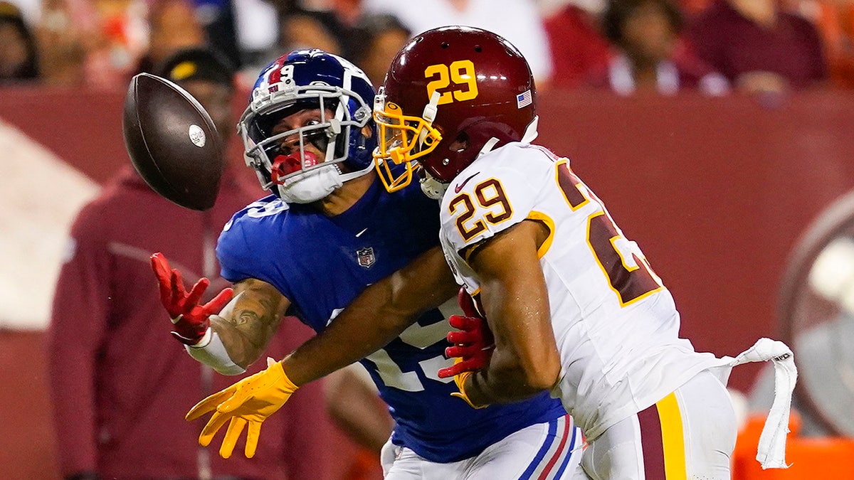 Washington Football Team cornerback Kendall Fuller (29) stops New York Giants wide receiver Kenny Golladay (19) from catching the ball during the second half of an NFL football game, Thursday, Sept. 16, 2021, in Landover, Md.