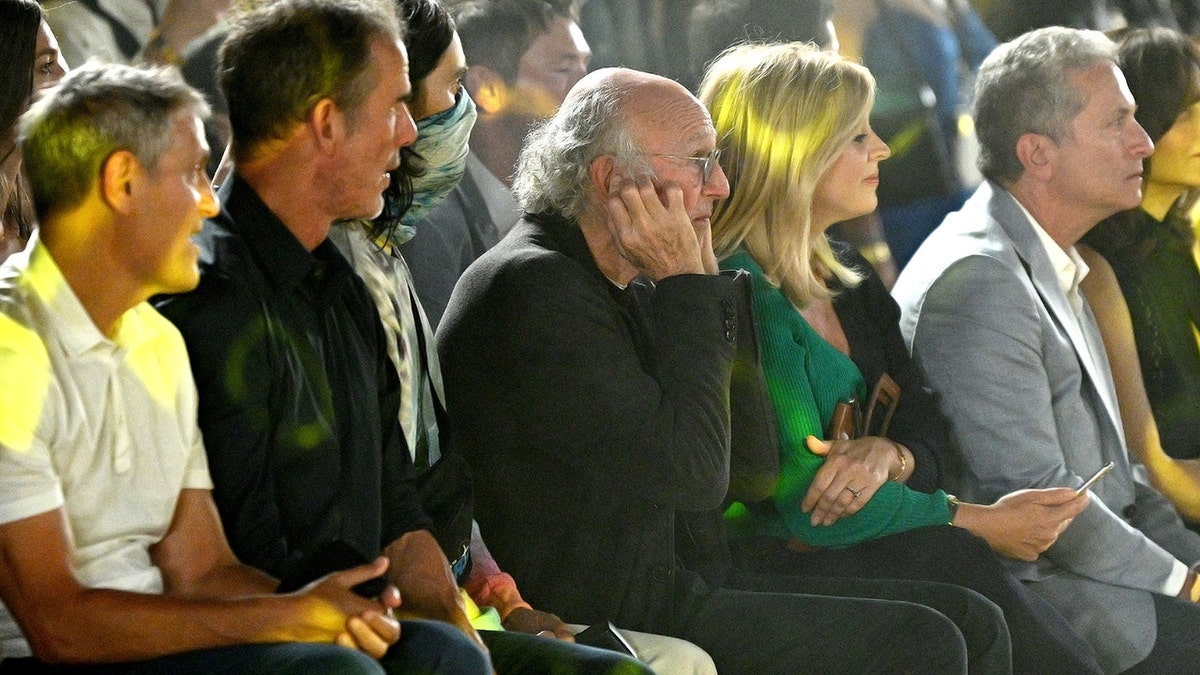 Larry David plugging his ears at a NYFW event.