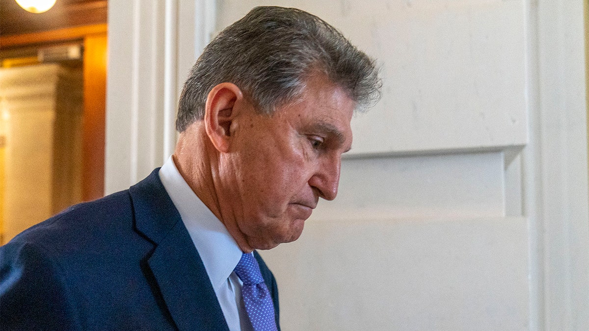 Sen. Joe Manchin, D-W.Va., walks out of the U.S. Capitol to speak to members of the media, Thursday, Sept. 30, 2021, in Washington. (AP Photo/Andrew Harnik)