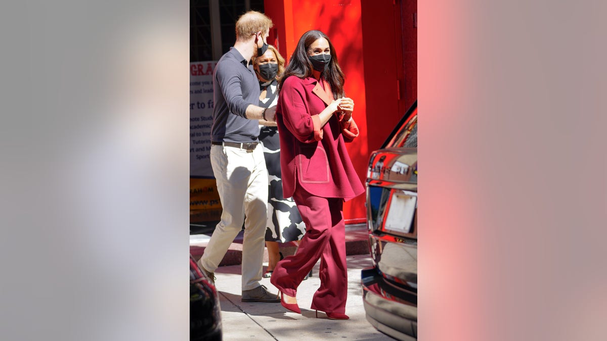 Meghan Markle Visits School and Donates to Local Restaurant in New York  City Wearing Loro Piana Red Cashmere Cape and Wide Leg Pants – Fashion Bomb  Daily