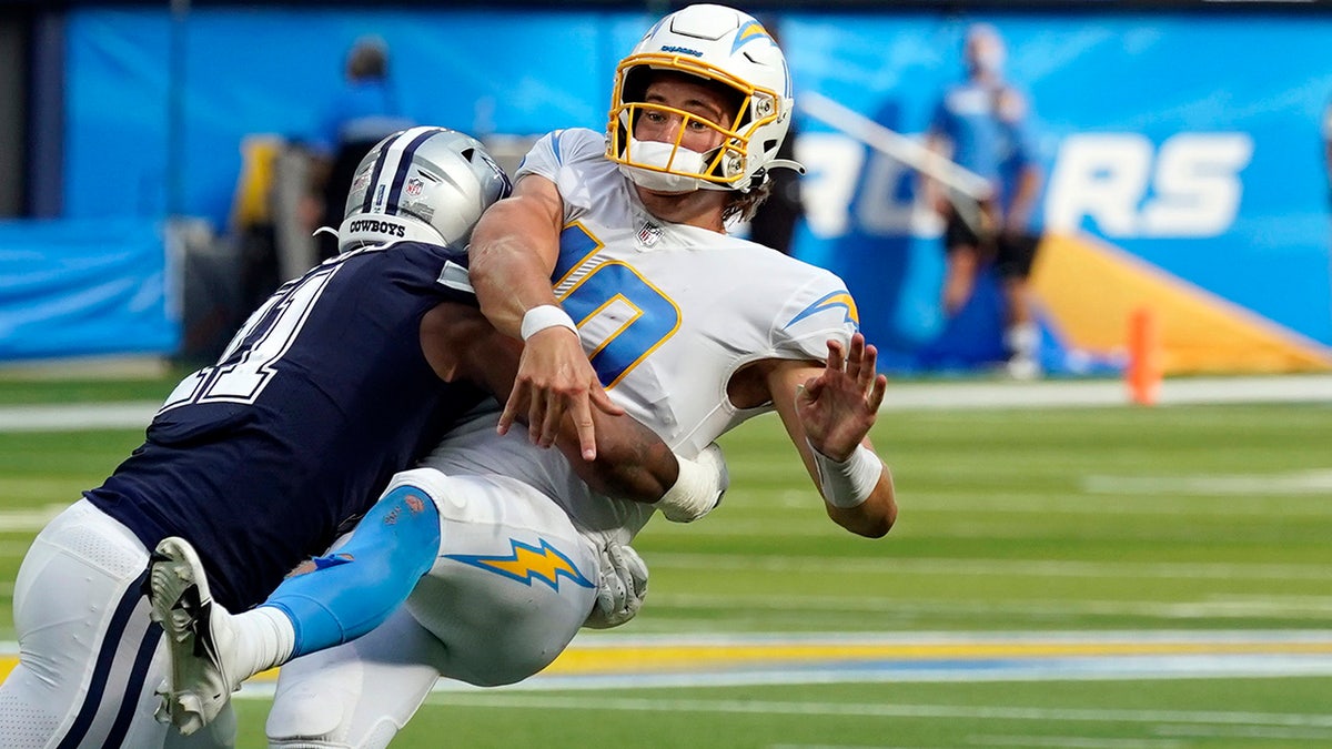 Los Angeles Chargers quarterback Justin Herbert is hit by Dallas Cowboys linebacker Micah Parsons as he throws during the second half of an NFL football game Sunday, Sept. 19, 2021, in Inglewood, Calif. 