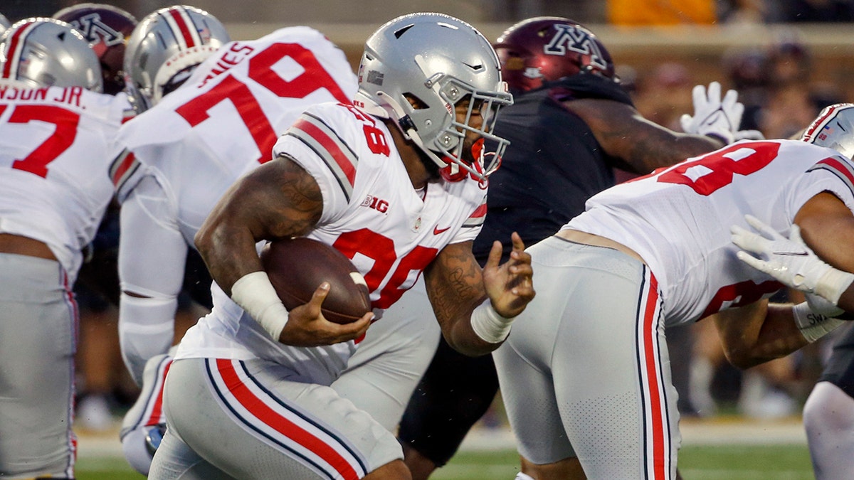Ohio State running back Miyan Williams (28) rushes for a touchdown against Minnesota in the first quarter of an NCAA college football game Thursday, Sept. 2, 2021, in Minneapolis. (AP Photo/Bruce Kluckhohn)
