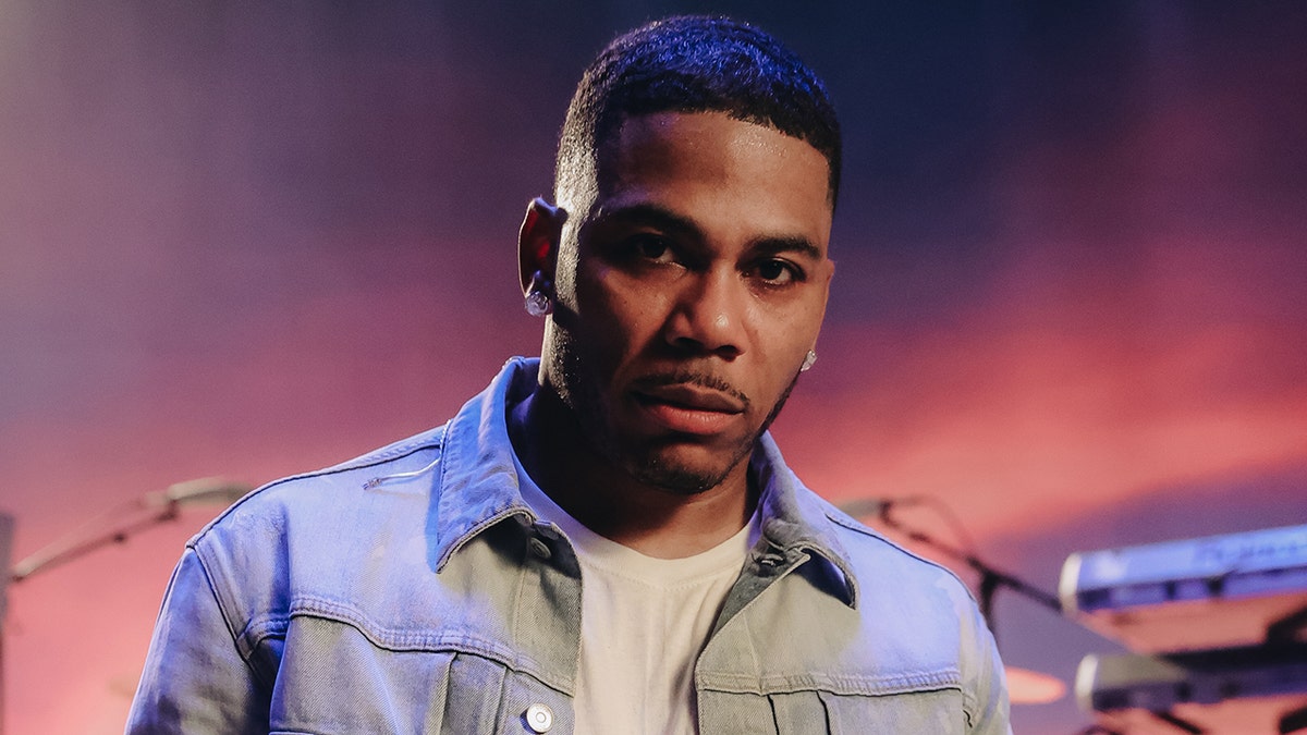 Nelly wears denim jacket