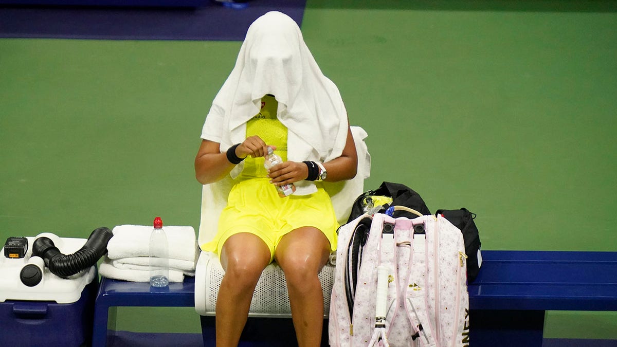 Naomi Osaka, of Japan, covers her head between games against Leylah Fernandez, of Canada, at the third round of the US Open tennis championships, Friday, Sept. 3, 2021, in New York City. (Associated Press)