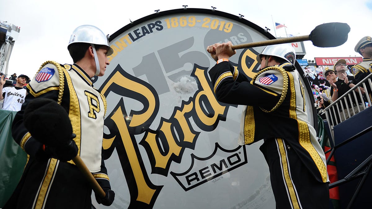 Members of the Purdue Boilermakers hit the Purdue Big Bass Drum before the bowl game against the Auburn Tigers in the 2018 Music City Bowl at Nissan Stadium. 