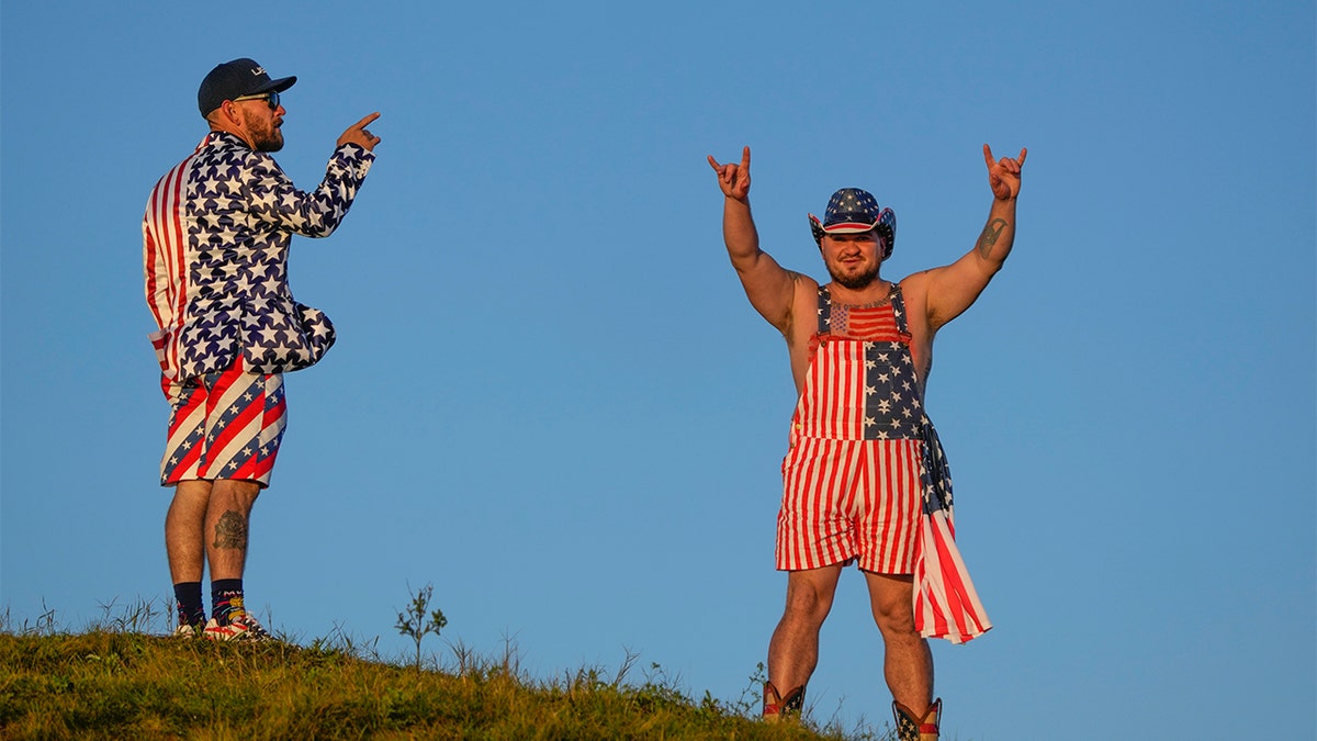 Fans stand on a hill overlooking the third hole during a foursomes match the Ryder Cup at the Whistling Straits Golf Course Saturday, Sept. 25, 2021, in Sheboygan, Wis. (AP Photo/Charlie Neibergall)