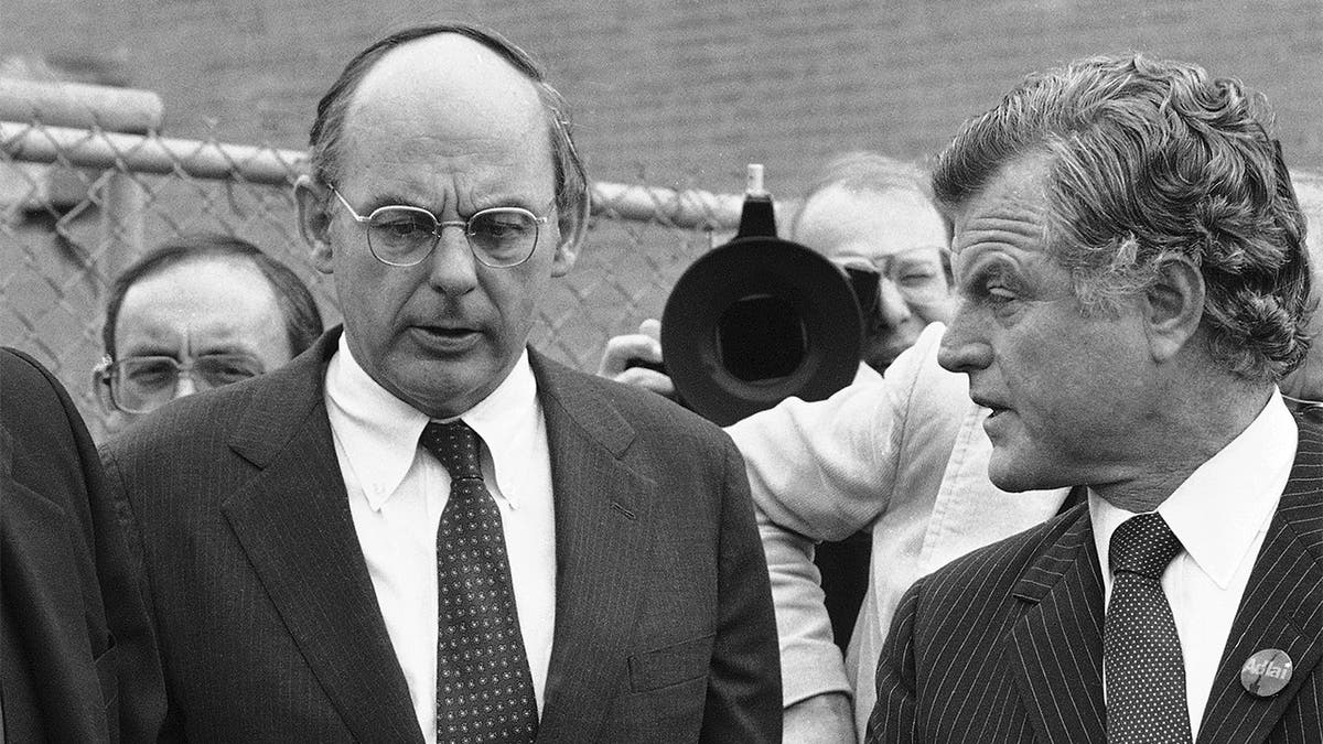 FILE - In this Oct. 14, 1982, file photo, Illinois Democratic gubernatorial candidate Adlai Stevenson III, left, talks with Sen. Edward Kennedy, right, talk as they finish a series of appearances in Chicago. Stevenson III, of Illinois, has died at his home on Chicago’s North Side. He was 90. On Tuesday, Sept. 7, 2021, his son Adlai Stevenson IV confirmed the Democrat’s death and said his father had dementia. (AP Photo/File)