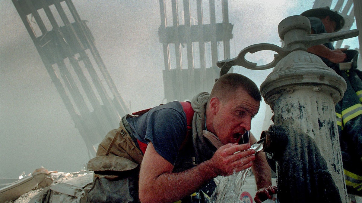 Woodmere Long Island Volunteer Firefighter Michael Sauer drinks from a fire hydrant on 9/11/01