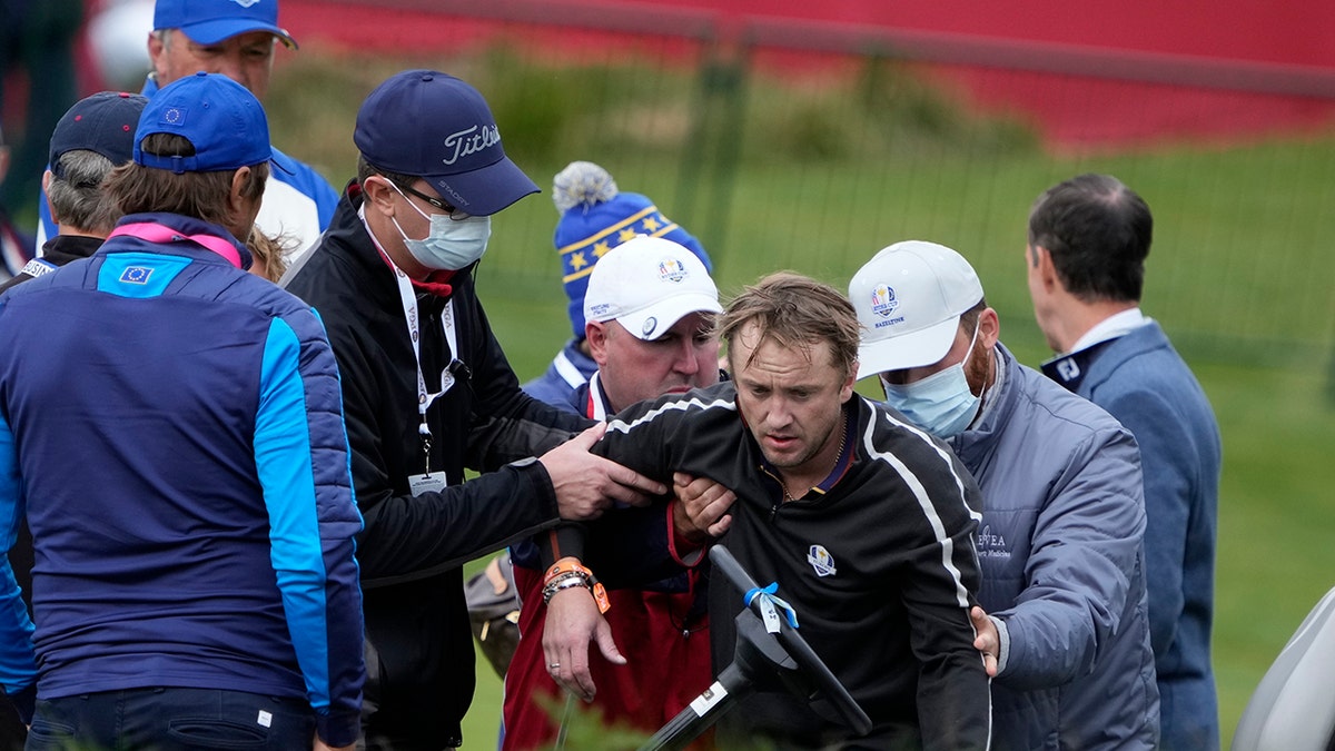 Actor Tom Felton is helped after collapsing on the 18th hole during a practice day at the Ryder Cup at the Whistling Straits Golf Course
