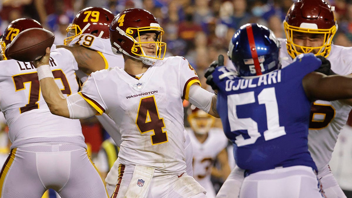 Washington Football Team quarterback Taylor Heinicke (4) passes the ball as New York Giants linebacker Azeez Ojulari (51) defends in the fourth quarter at FedExField.