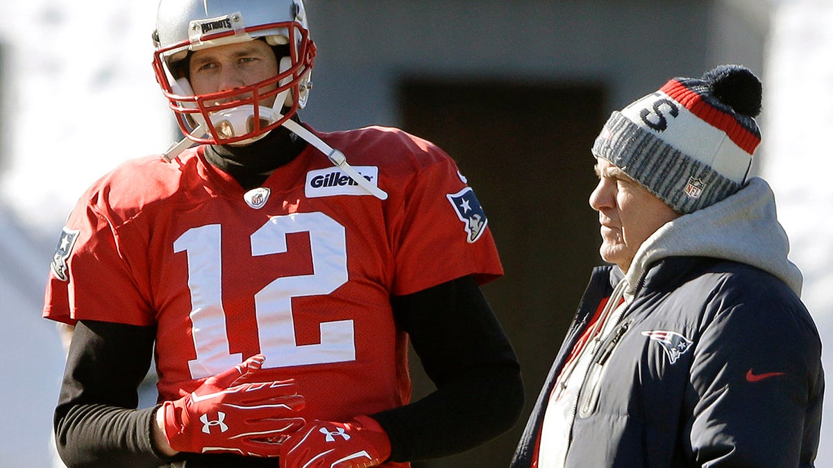 FILE - New England Patriots quarterback Tom Brady, left, stands with head coach Bill Belichick, right, during an NFL football practice, Thursday, Jan. 18, 2018, in Foxborough, Mass. Without Bill Belichick, Tom Brady won his seventh Super Bowl and is on pace to throw a career-high 53 touchdown passes at age 44. Without Brady under center, Belichick is 54-61 over his career, including 8-11 since the future Hall of Fame quarterback left New England for Tampa Bay.