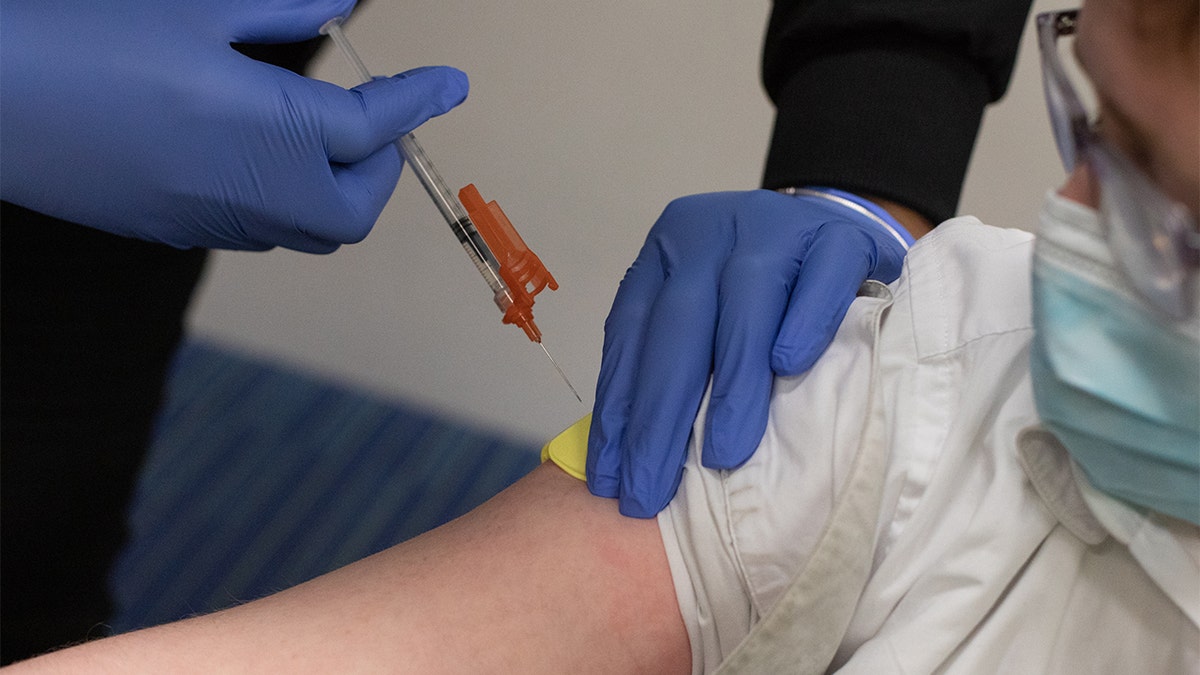 A health care worker administers a dose of a Pfizer-BioNTech Covid-19 vaccine to a child at a pediatrician's office in Bingham Farms, Michigan.