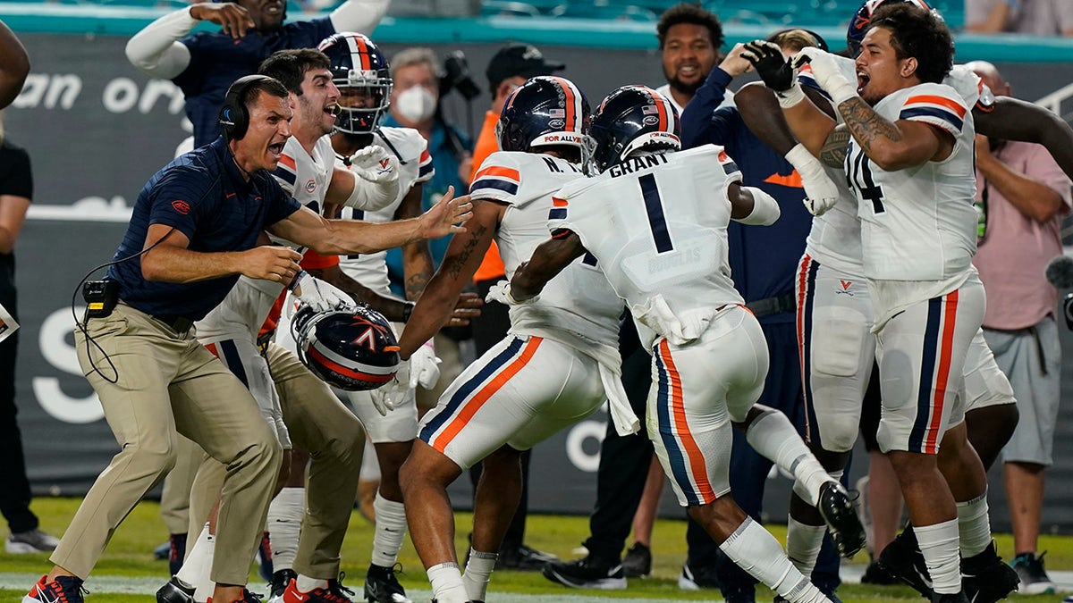 Virginia celebrates after scoring a safety during the first half of a NCAA college football game against Miami, Thursday, Sept. 30, 2021, in Miami Gardens, Fla.