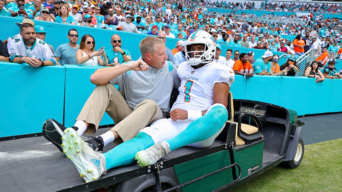 Miami Dolphins quarterback Tua Tagovailoa (1) is assisted off the field during the first half of an NFL football game against the Buffalo Bills, Sunday, Sept. 19, 2021, in Miami Gardens, Fla.