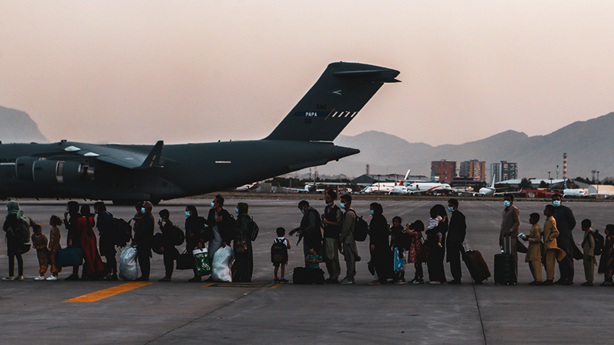 Evacuees wait to board a Boeing C-17 Globemaster III during an evacuation at Hamid Karzai International Airport, Kabul, Afghanistan, Aug. 23.