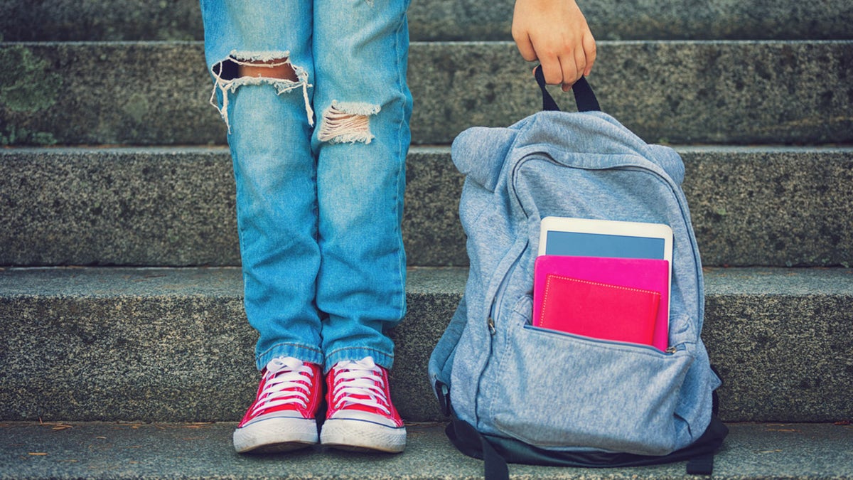 file photo of school kid grabbing backpack