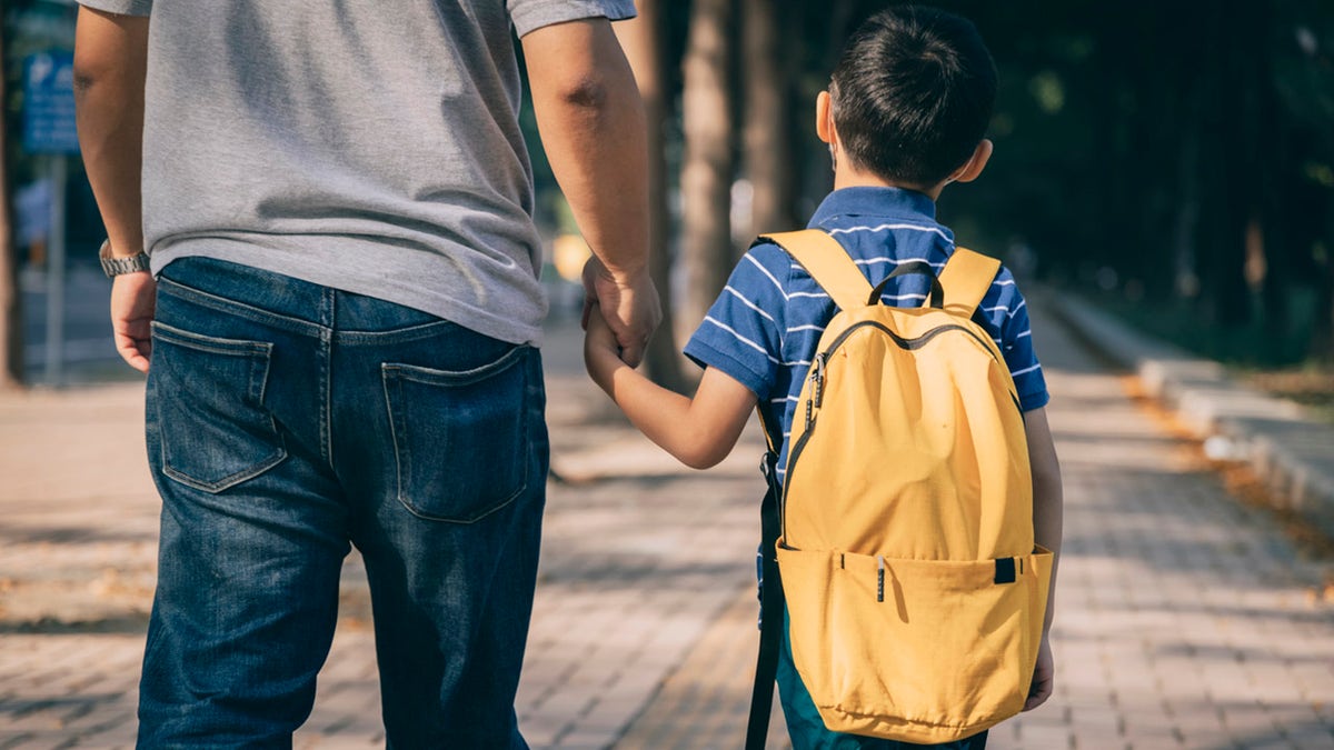 Dad and son walk to school