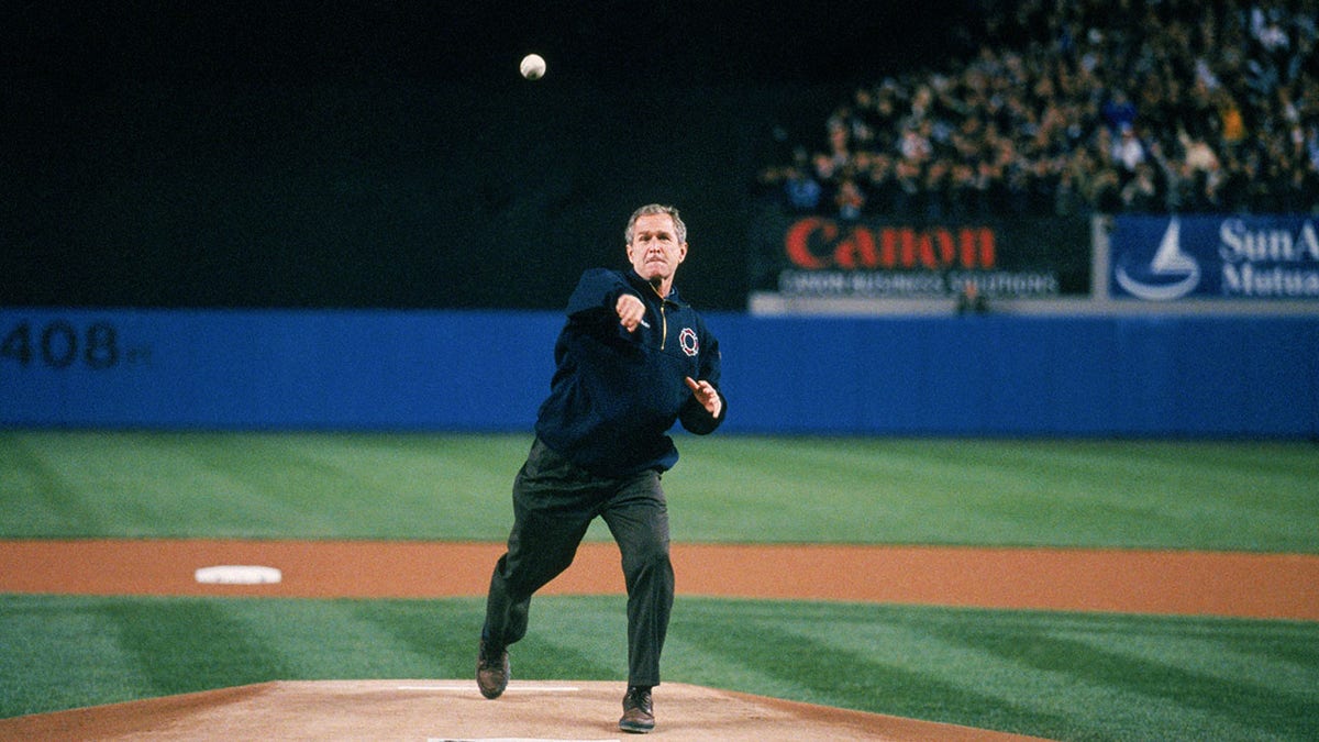 President George W. Bush throws out the ceremonial first pitch before Game Three of  the 2001 World Series between the Arizona Diamondbacks and the New York Yankees at Yankee Stadium on October 30, 2001 in Bronx, New York.  The Yankees defeated the Diamondbacks 2-1.  (Photo by Rich Pilling/MLB via Getty Images)