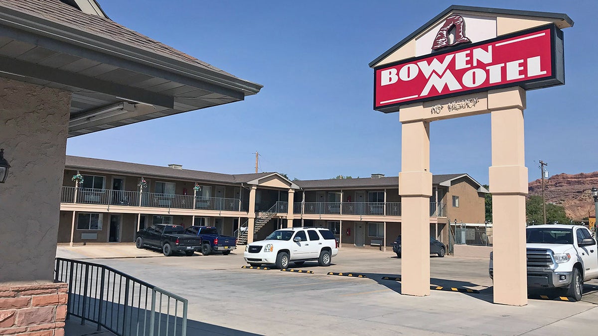 Bowen Motel sign towers above sunny parking lot