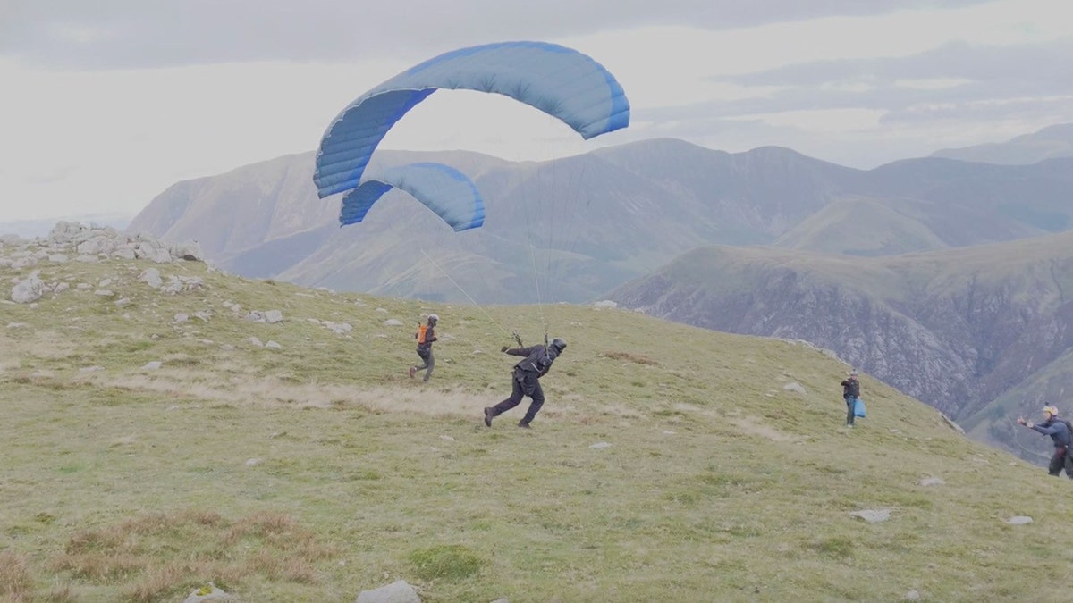 Cruise parachuted off a cliff. He was practicing a stunt for his upcoming movie. 