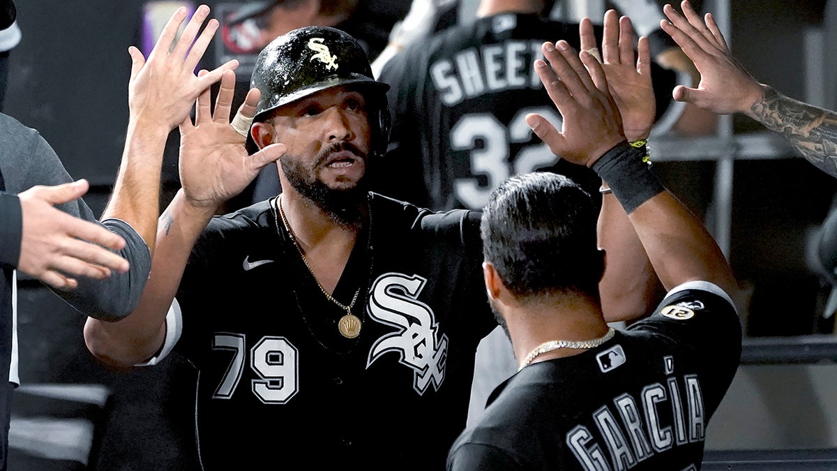 Chicago White Sox's Jose Abreu is congratulated in the dugout after scoring on a single by Yasmani Grandal during the sixth inning of the team's baseball game against the Los Angeles Angels on Wednesday, Sept. 15, 2021, in Chicago. 