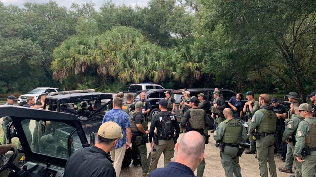 Law enforcement officials conduct a search of the vast Carlton Reserve in the Sarasota, Florida, area for Brian Laundrie on Saturday, Sept. 18, 2021.  (North Port Police Department via AP)