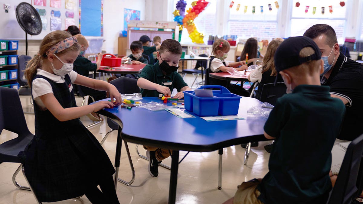 Kids in classroom with COVID-19 masks