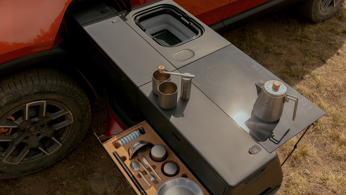 The Rivian Camp Kitchen fits into the R1T's Gear Tunnel storage compartment.
