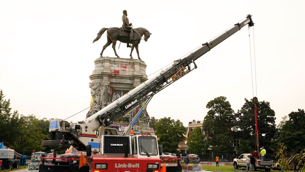 Crews prepare one of the country's largest remaining monuments to the Confederacy, a towering statue of Confederate General Robert E. Lee on Monument Avenue, Wednesday, Sept. 8, 2021, in Richmond, Virginia. 