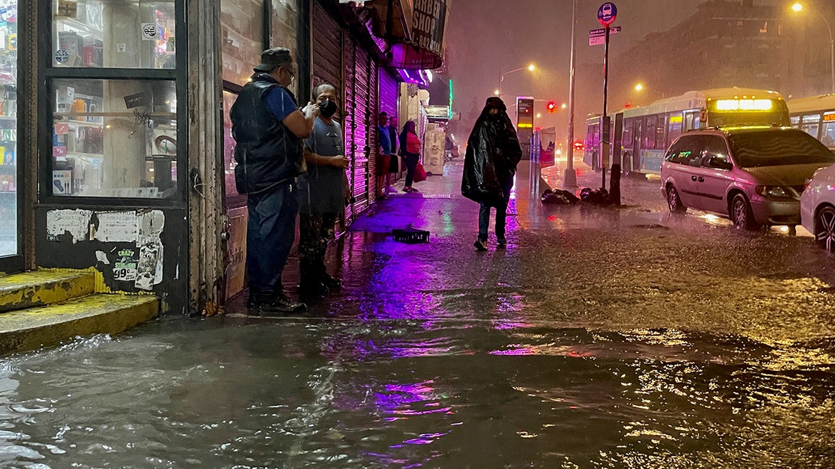 People make their way in rainfall from the remnants of Hurricane Ida on Sept. 1, 2021, in the Bronx borough of New York City. (Getty Images)