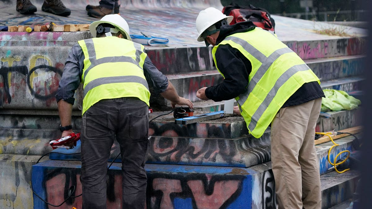 Crews attempt to locate a time capsule said to be buried in the base of the statue of on Monument Avenue in Richmond, Va., Thursday, Sept. 9, 2021. The statue was removed from the pedestal on Wednesday. (AP Photo/Steve Helber)