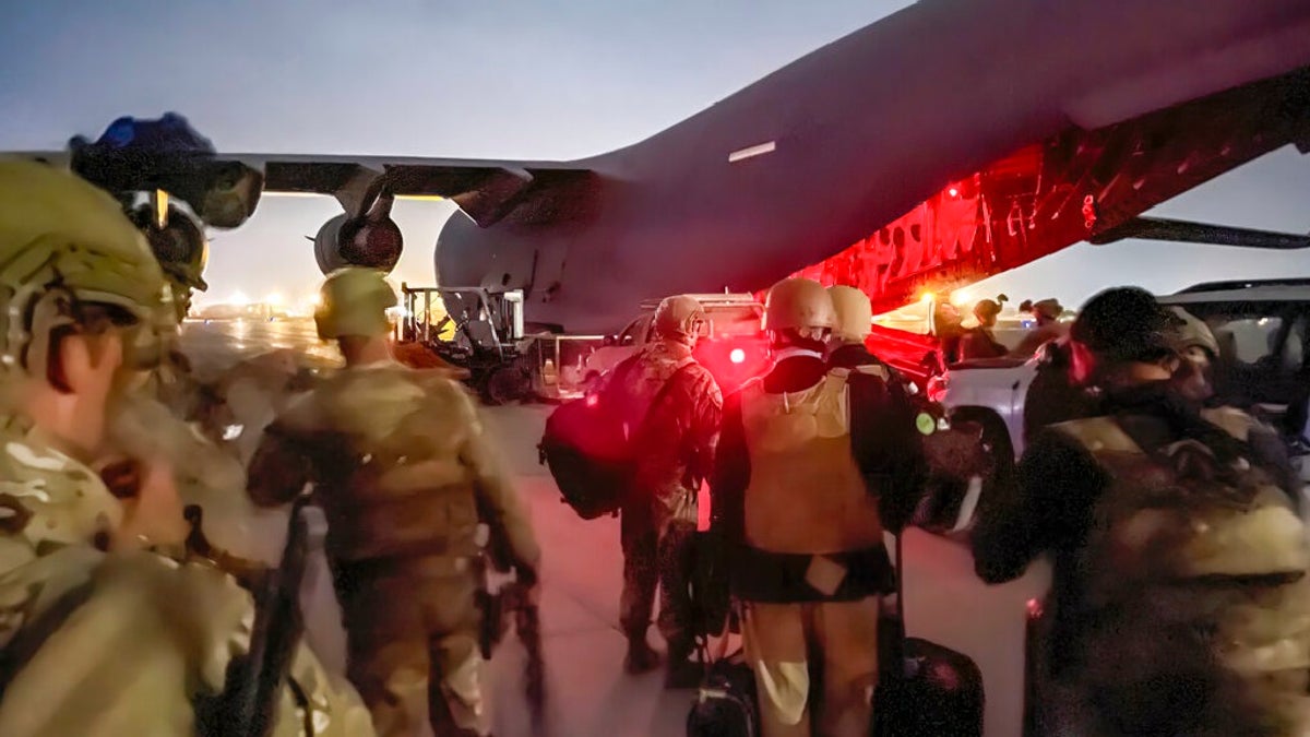 In this image provided by the U.S. Army, paratroopers assigned to the 82nd Airborne Division, and others, prepare to board a C-17 cargo plane at Hamid Karzai International Airport in Kabul, Afghanistan, on Monday.