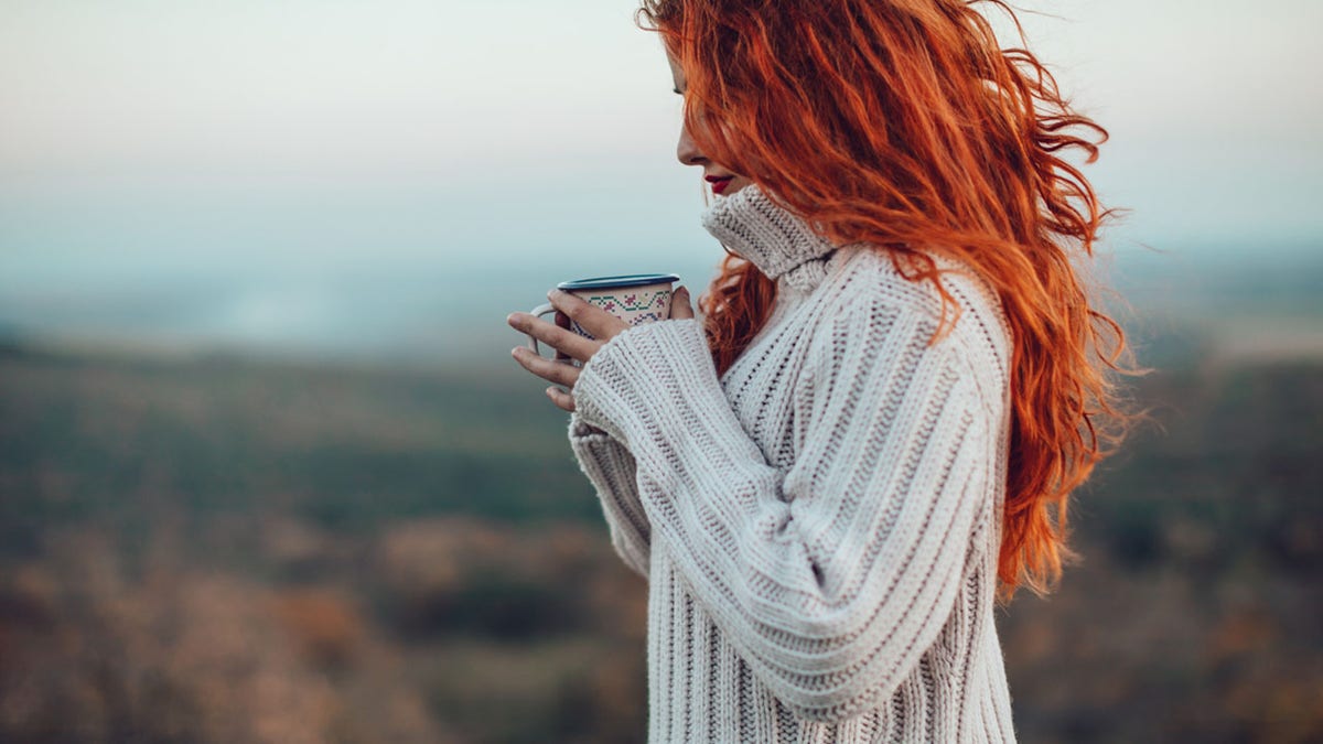 A girl wearing a white sweater