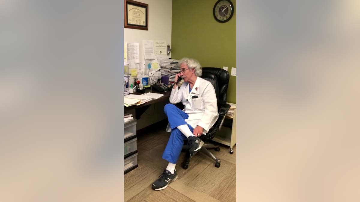 Pregnancy doctor on phone call in doctor's office