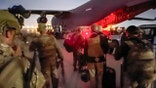 In this image provided by the U.S. Army, paratroopers assigned to the 82nd Airborne Division, and others, prepare to board a C-17 cargo plane at Hamid Karzai International Airport in Kabul, Afghanistan, Monday, Aug. 30, 2021. (Master Sgt. Alexander Burnett/U.S. Army via AP)
