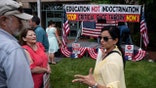 People talk before the start of a rally against "critical race theory" (CRT) being taught in schools at the Loudoun County Government center in Leesburg, Virginia on June 12, 2021. (Photo by ANDREW CABALLERO-REYNOLDS / GETTY)