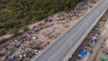 Migrants, many from Haiti, are seen at an encampment along the Del Rio International Bridge, Wednesday, Sept. 22, 2021, in Del Rio, Texas. (AP Photo/Julio Cortez)