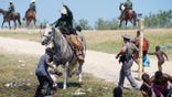 EDITORS NOTE: Graphic content / A United States Border Patrol agent on horseback tries to stop a Haitian migrant from entering an encampment on the banks of the Rio Grande near the Acuna Del Rio International Bridge in Del Rio, Texas on September 19, 2021. - The United States said Saturday it would ramp up deportation flights for thousands of migrants who flooded into the Texas border city of Del Rio, as authorities scramble to alleviate a burgeoning crisis for President Joe Biden's administration. (Photo by PAUL RATJE / AFP) (Photo by PAUL RATJE/AFP via Getty Images)