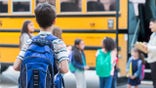 Kid standing near bus