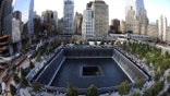 FILE PHOTO: Families visit the South Memorial Pool during tenth anniversary ceremonies at the World Trade Center site in New York, U.S., September 11, 2011. Robert Deutsch/Pool via REUTERS