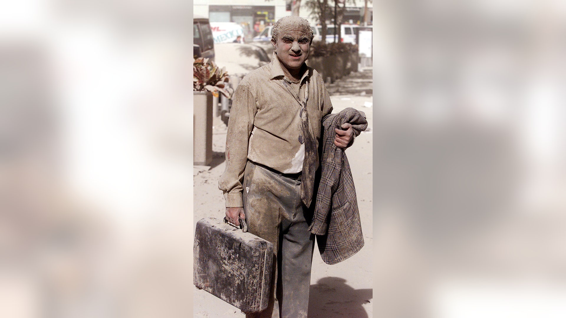 A man walks in the street near the World Trade Center towers in New York City, early Sept. 11, 2001. Both towers were hit by planes that crashed into the buildings, which collapsed shortly after. (REUTERS/Shannon Stapleton)
