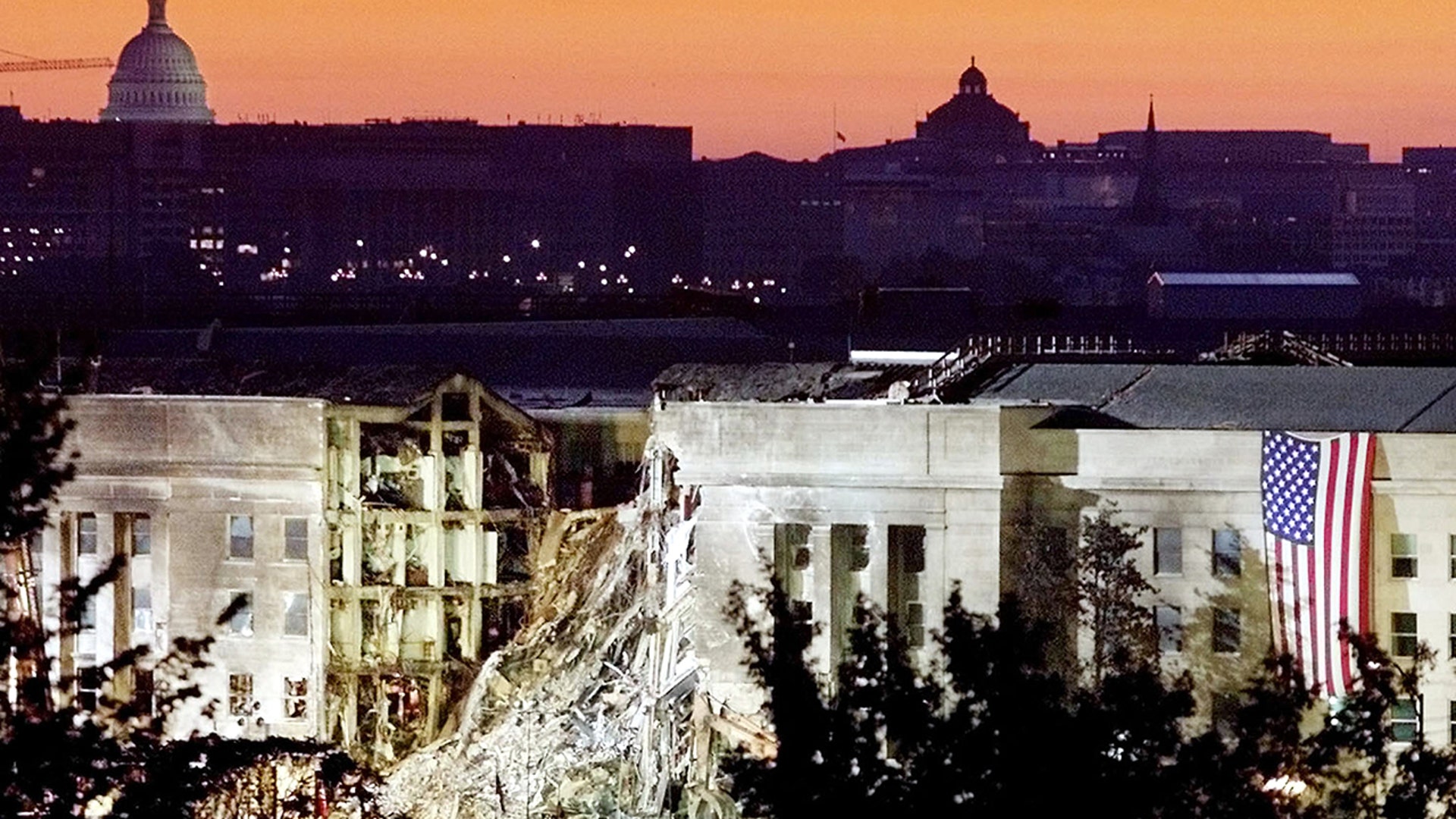 The damaged area of the Pentagon building, where a commercial jetliner slammed into it on Sept. 11, 2001, is seen in the early morning at sunrise with the U.S. Capitol Building in the background, Sept. 16, 2001. Both the Pentagon and the World Trade Center buildings in New York City were attacked by hijacked commercial airliners.
